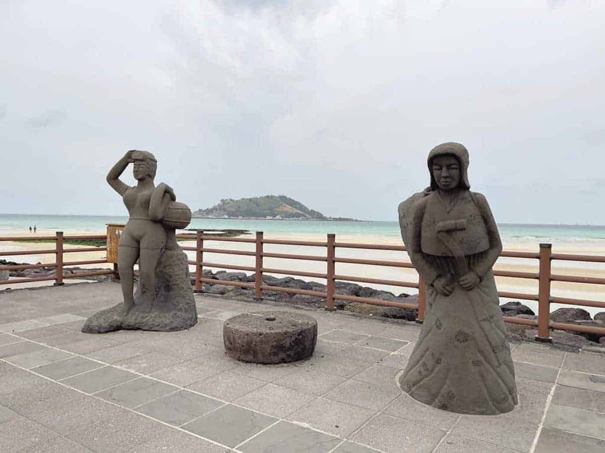 2 stone figures on a beach along the West Coast of Jeju Island.