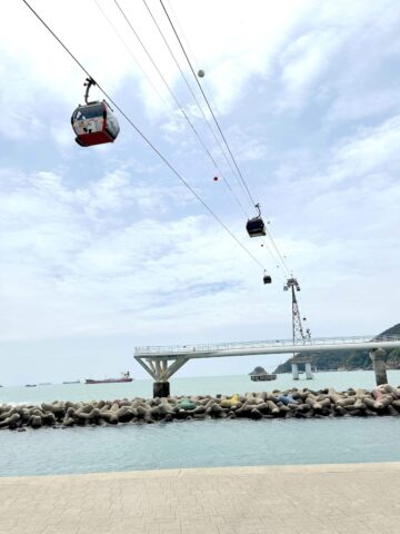 Busan Air Cruise cable cars travelling over Songdo Beach.