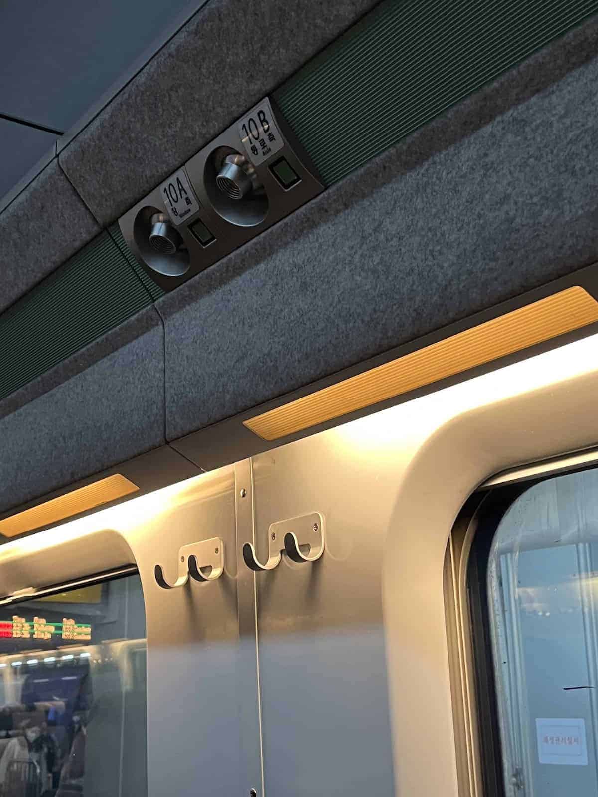 A place to hang your coat and lighting above the KTX seat.